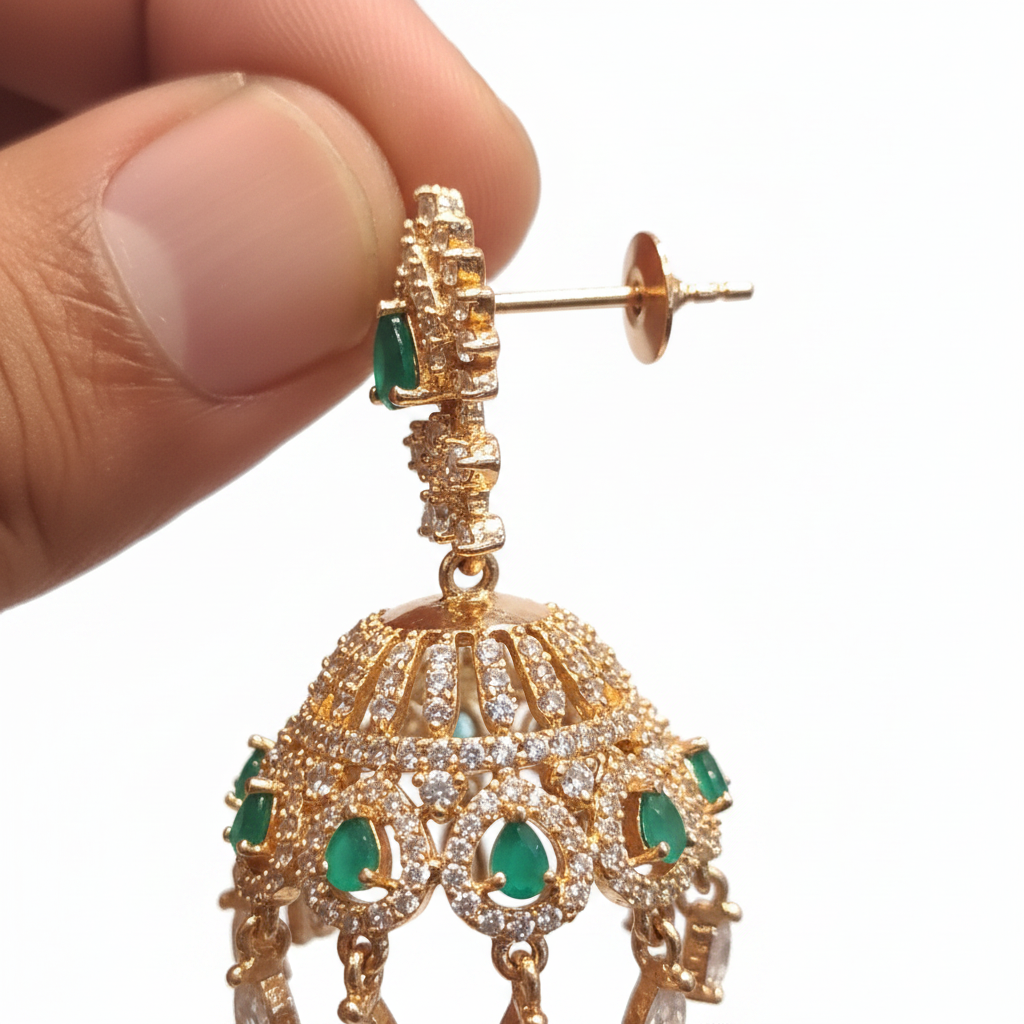 Close-up macro detail of CZ jhumka earring with green stone and crystal drops