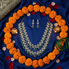 Emerald Teardrop Necklace & Earring Set – flat lay cultural context with silk and florals
