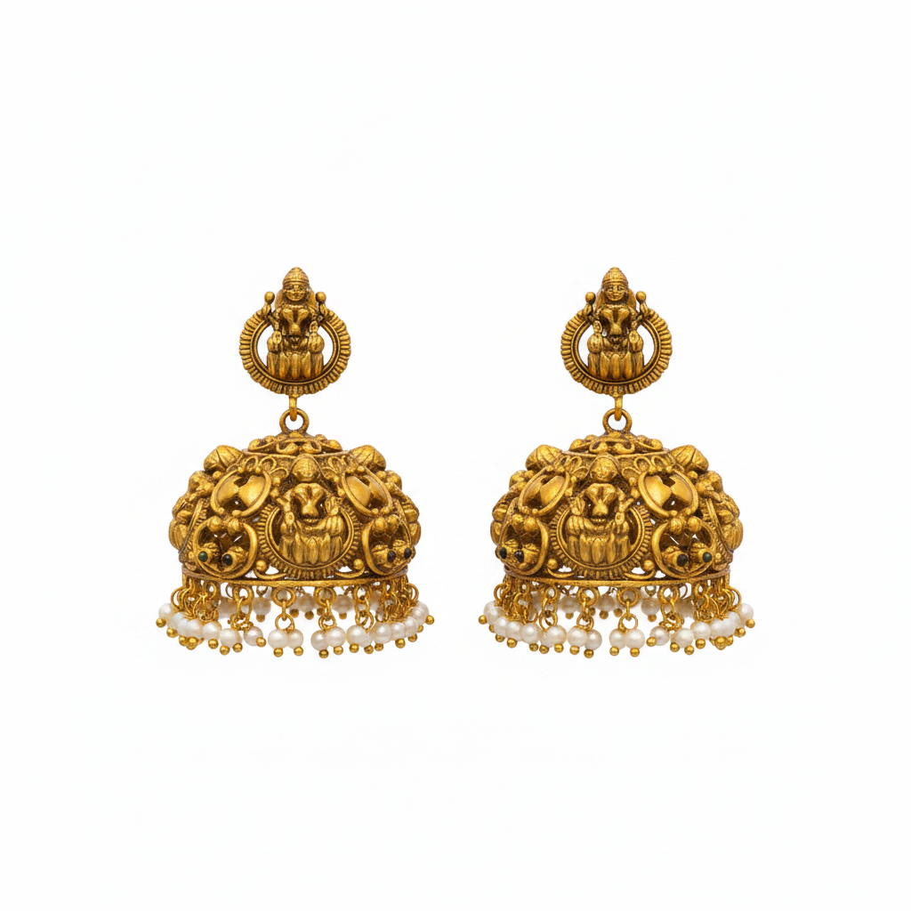 Flat lay of antique Lakshmi temple jhumka earrings on white background