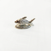 Silver fish idol with textured scales on a decorative oval base against a white background