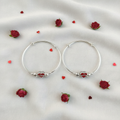 Lifestyle flat lay of silver red heart hoop bangles for kids