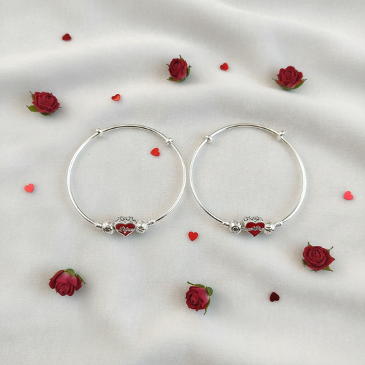 Lifestyle flat lay of silver red heart hoop bangles for kids