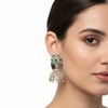 Model wearing CZ diamond hexagonal jhumka earrings green variant, white background