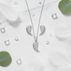 925 Silver Angel Wing Pendant Set – elegant flat lay with feathers and crystals