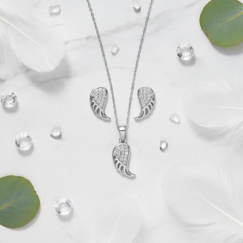 925 Silver Angel Wing Pendant Set – elegant flat lay with feathers and crystals