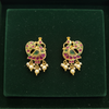 Jadau Kundan Peacock Earrings green velvet flat lay