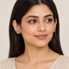 Model wearing the pink-and-green stud earrings
