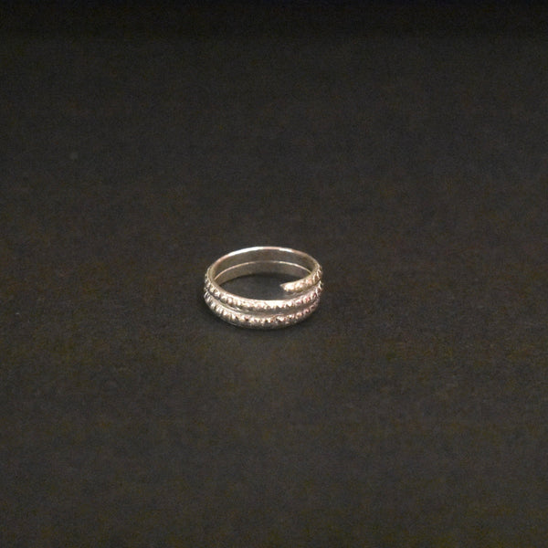 Silver ring on a dark textured background