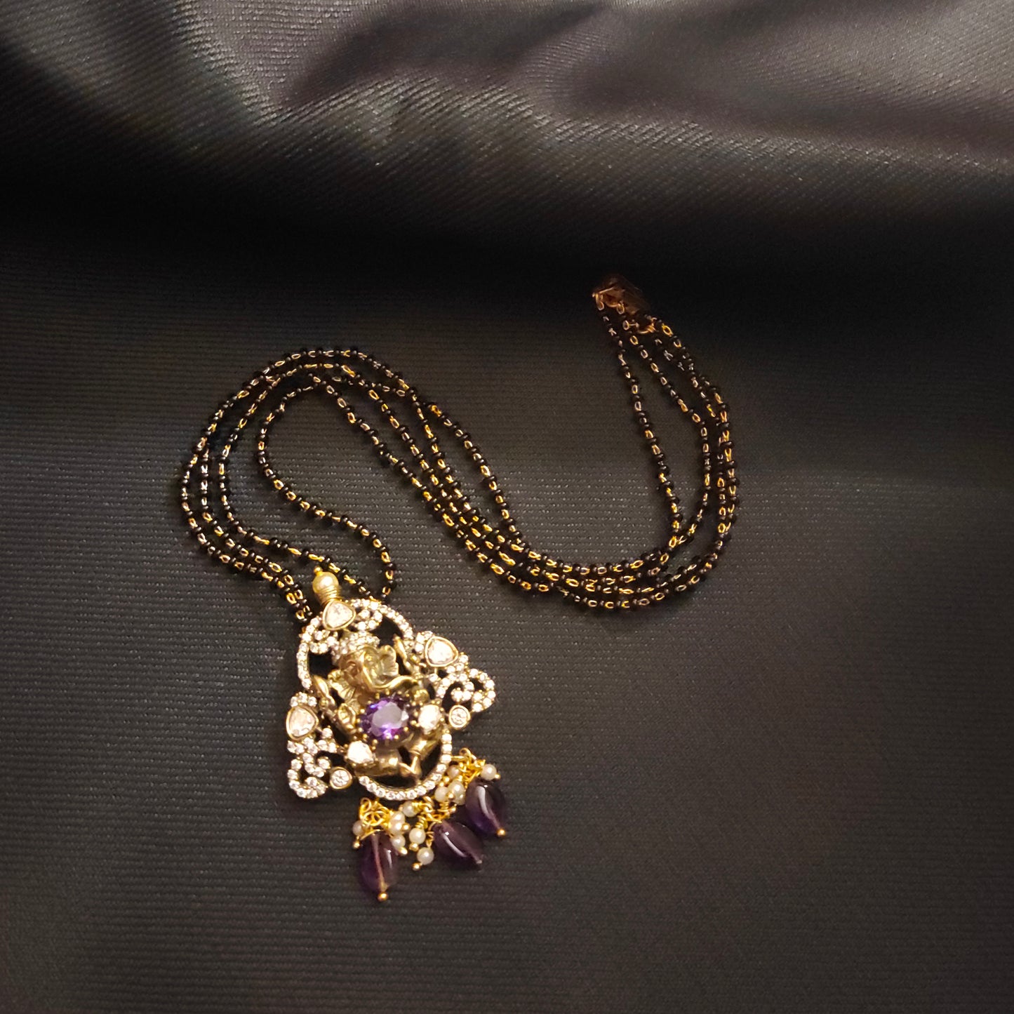 "Victorian Aura meets Divine Elegance: The Enchanting Ganesh Pendant Adorned with Black Beads Mangalsutra 36676559"