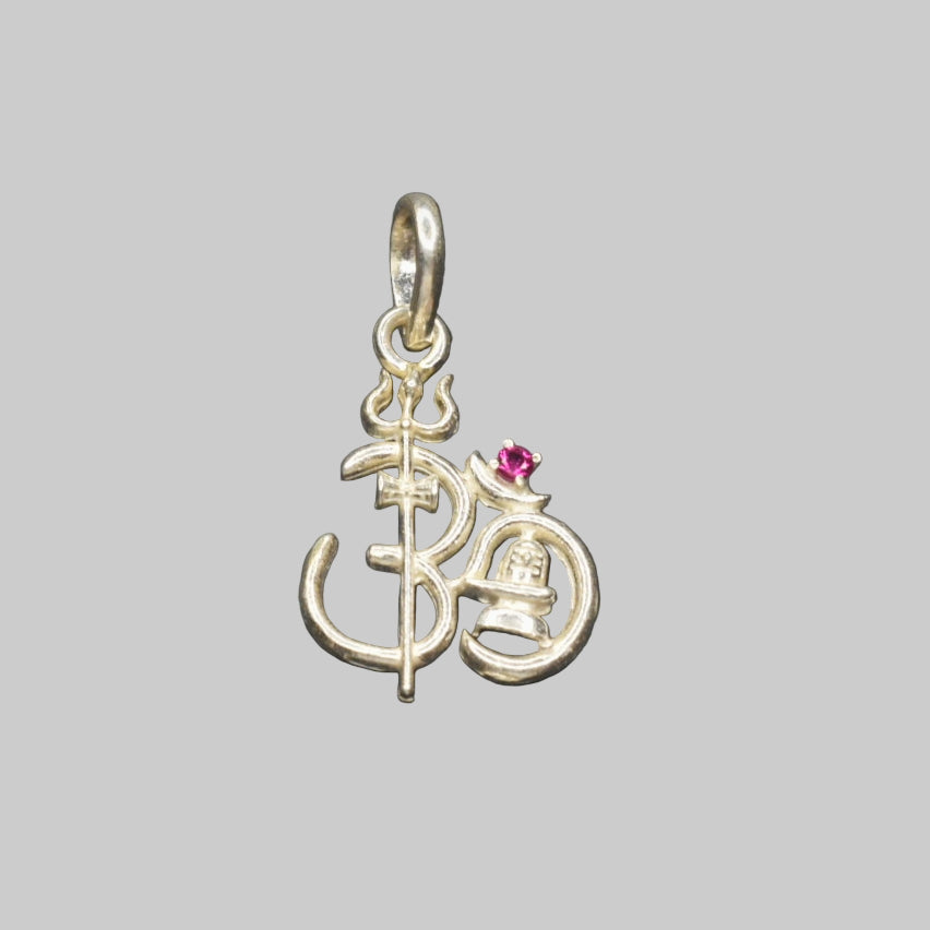 A sterling silver Om pendant with a small red stone, connected to a silver chain.