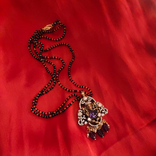"Victorian Aura meets Divine Elegance: The Enchanting Ganesh Pendant Adorned with Black Beads Mangalsutra 36676559"