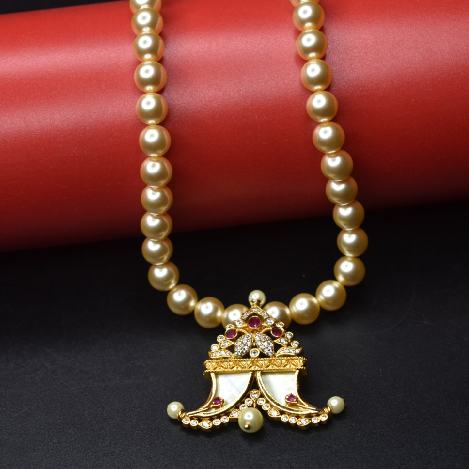 "Pearls of Elegance: Antique Finish Cz Puligoru Locket Necklace for Fashionable Kids"