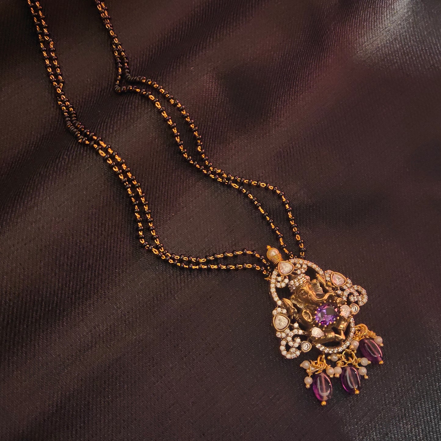 "Victorian Aura meets Divine Elegance: The Enchanting Ganesh Pendant Adorned with Black Beads Mangalsutra 36676559"