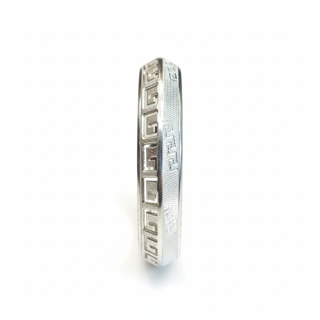 Silver temple bangle with Greek key pattern on white background