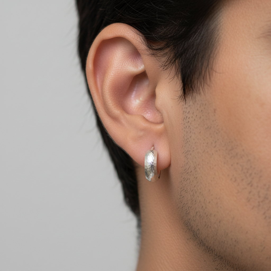 Sterling silver hoop earrings on man's ear